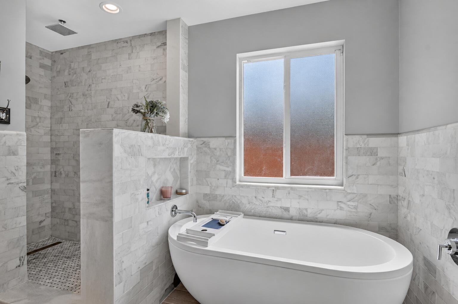 Primary bathroom soaking tub and walk-in shower at 631 SW 17th Street